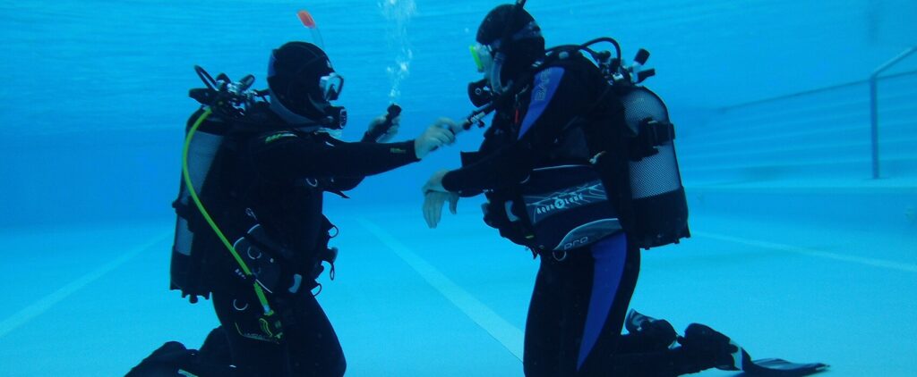 SSI Diving Courses in Croatia: Diving instructor training students underwater at diving RABAC in Istria.